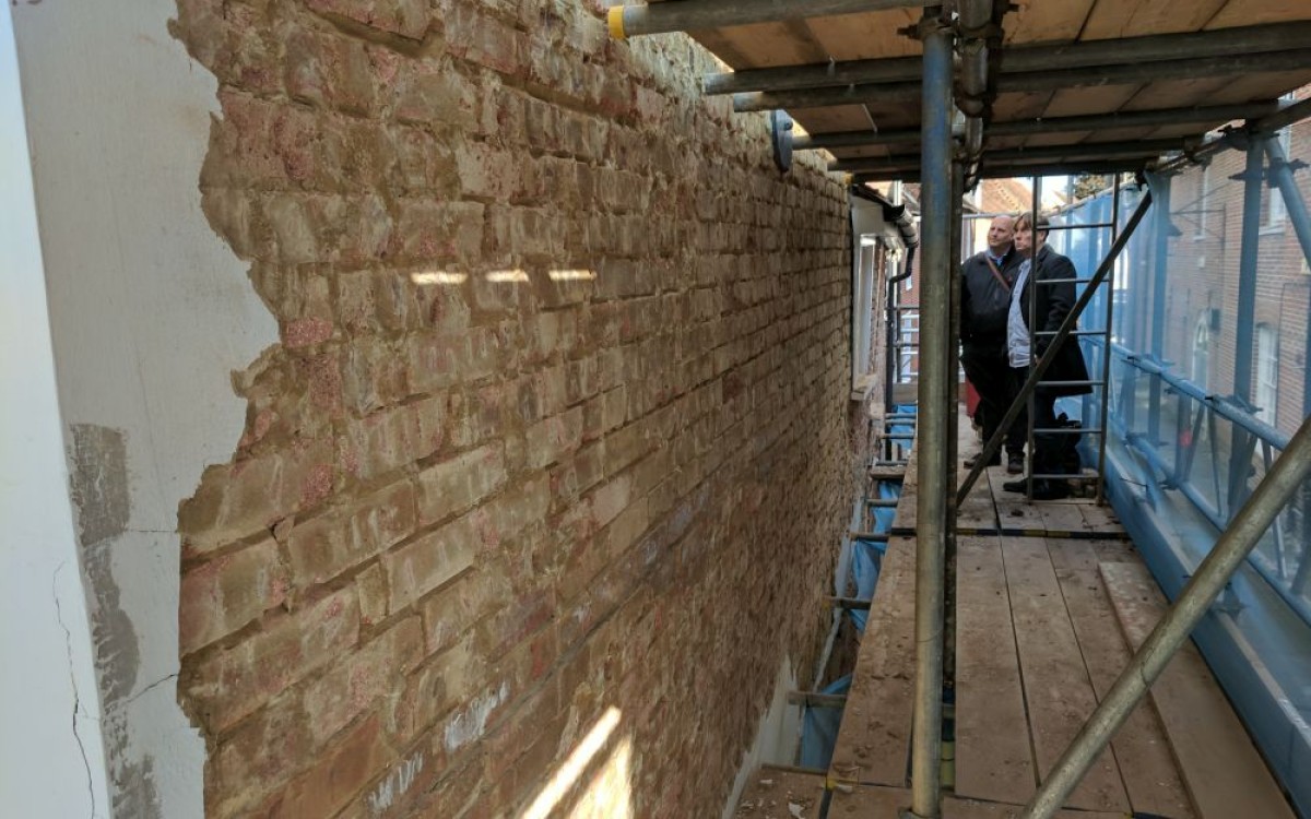 South elevation being stripped of non-porous render